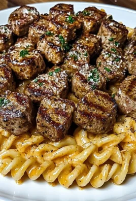 Creamy Garlic Butter Steak Bites with Spicy Cajun Alfredo Twisted Pasta